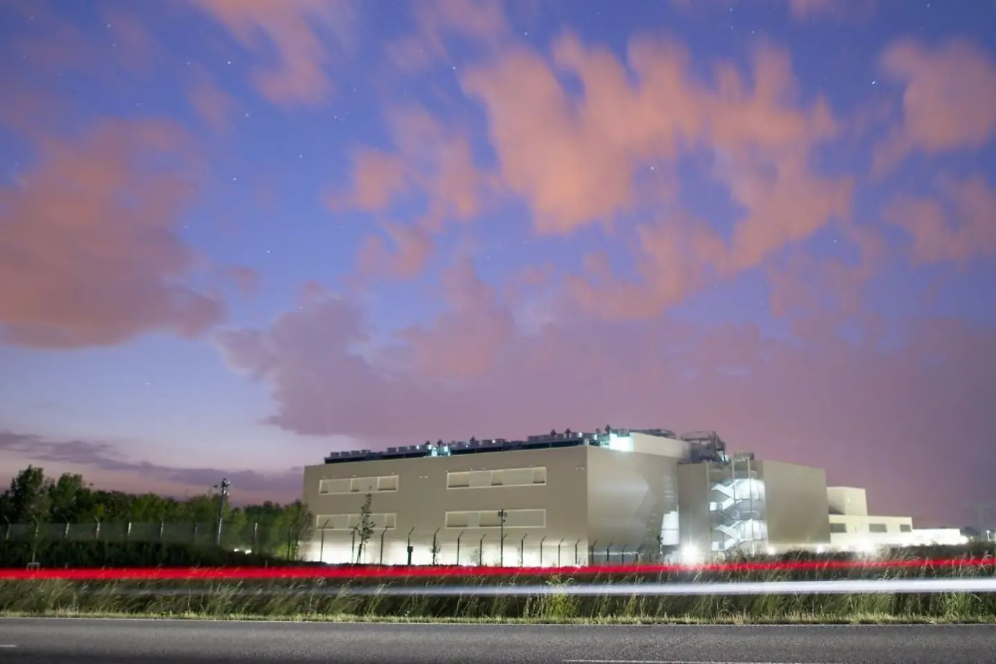 Data center in Biere at night with clouds.
