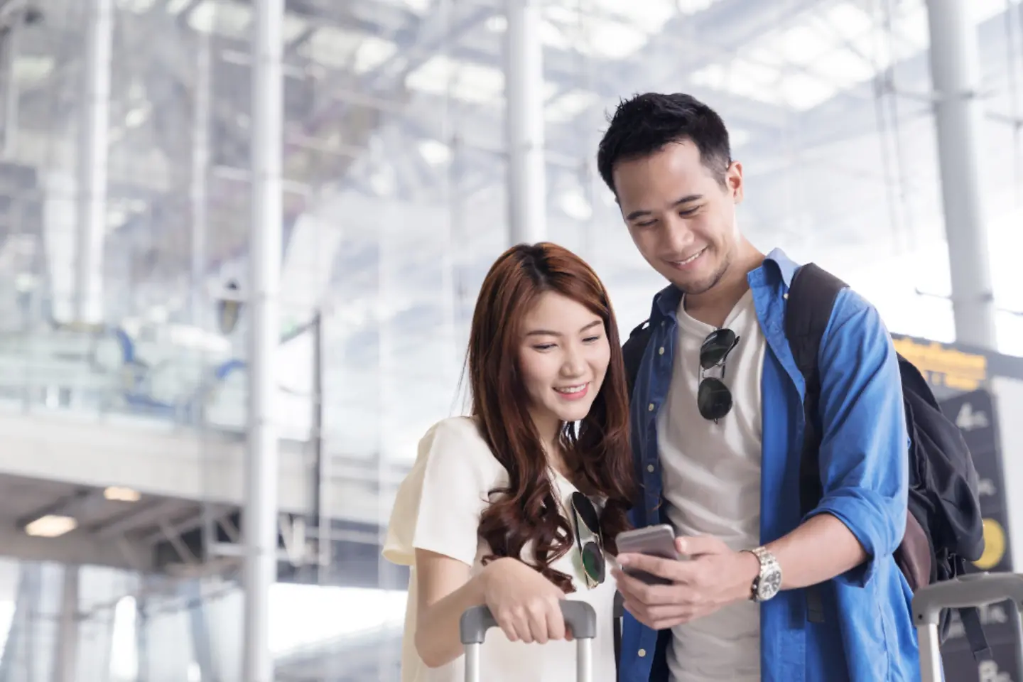 Passengers on their laptop in an airport enjoying superior connectivity and services