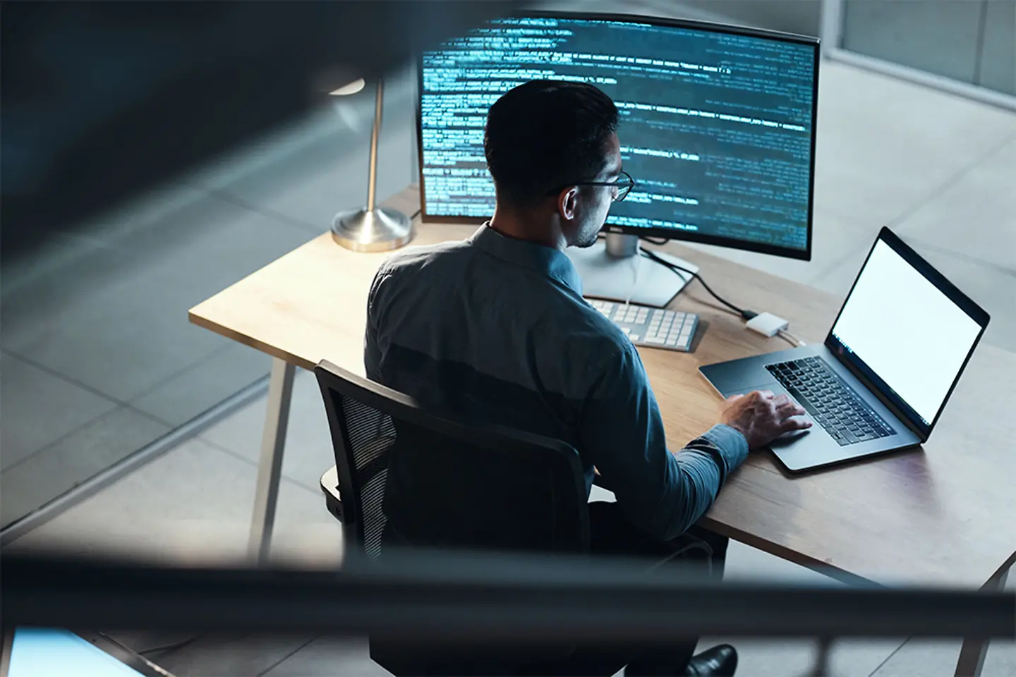 Programmer coding at night on laptop