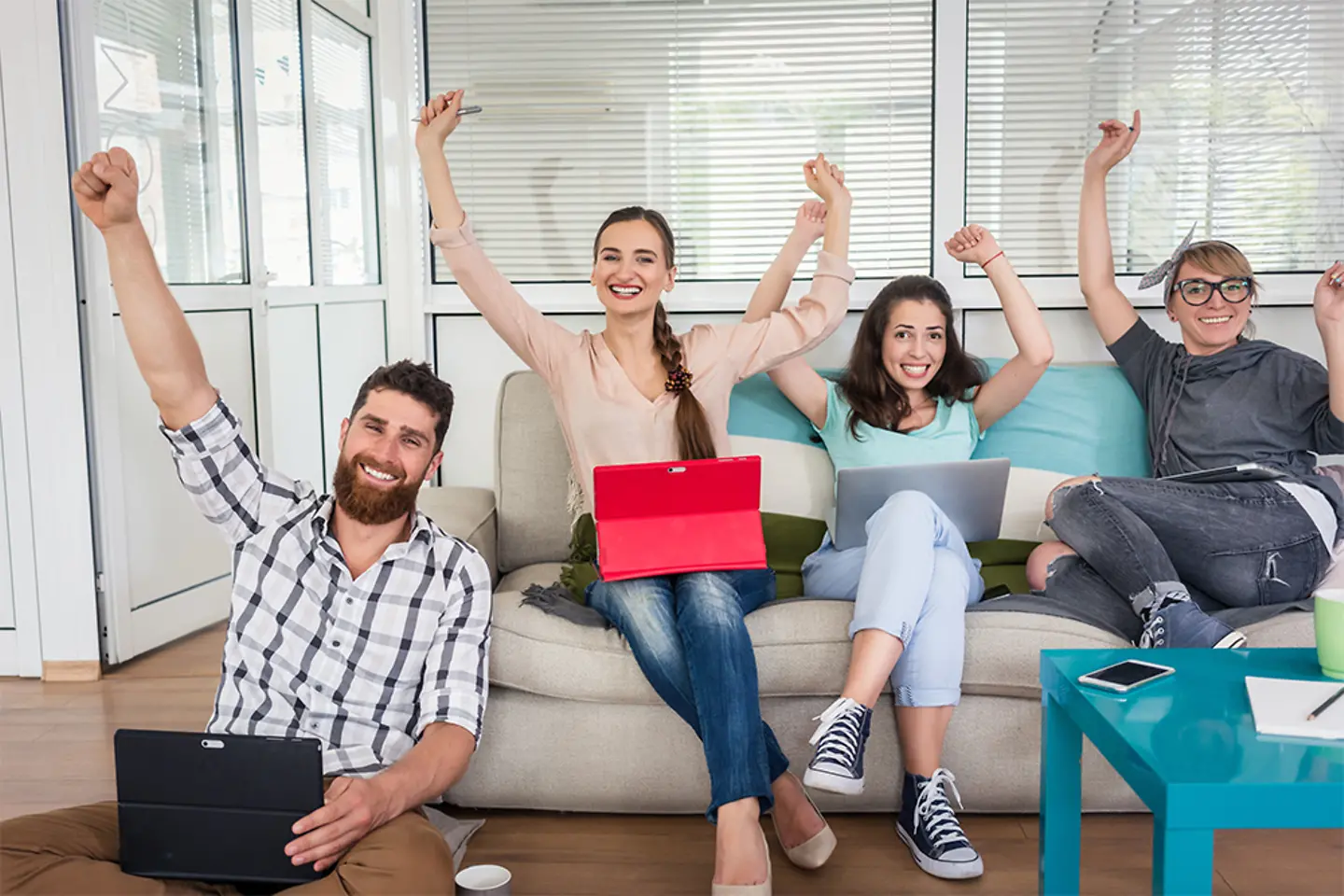 Four young people use coworking office