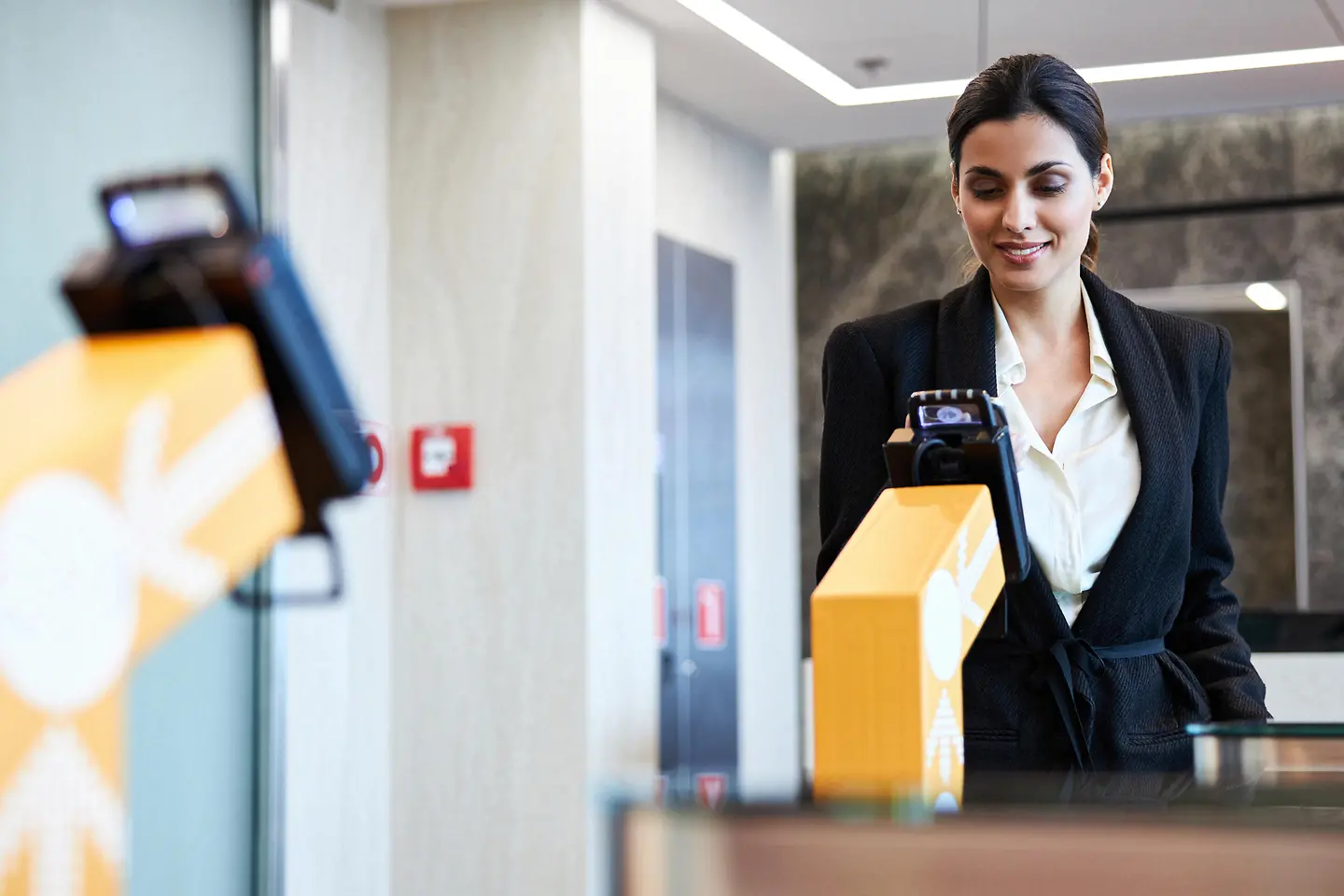 Business woman showing digital ID to access office building
