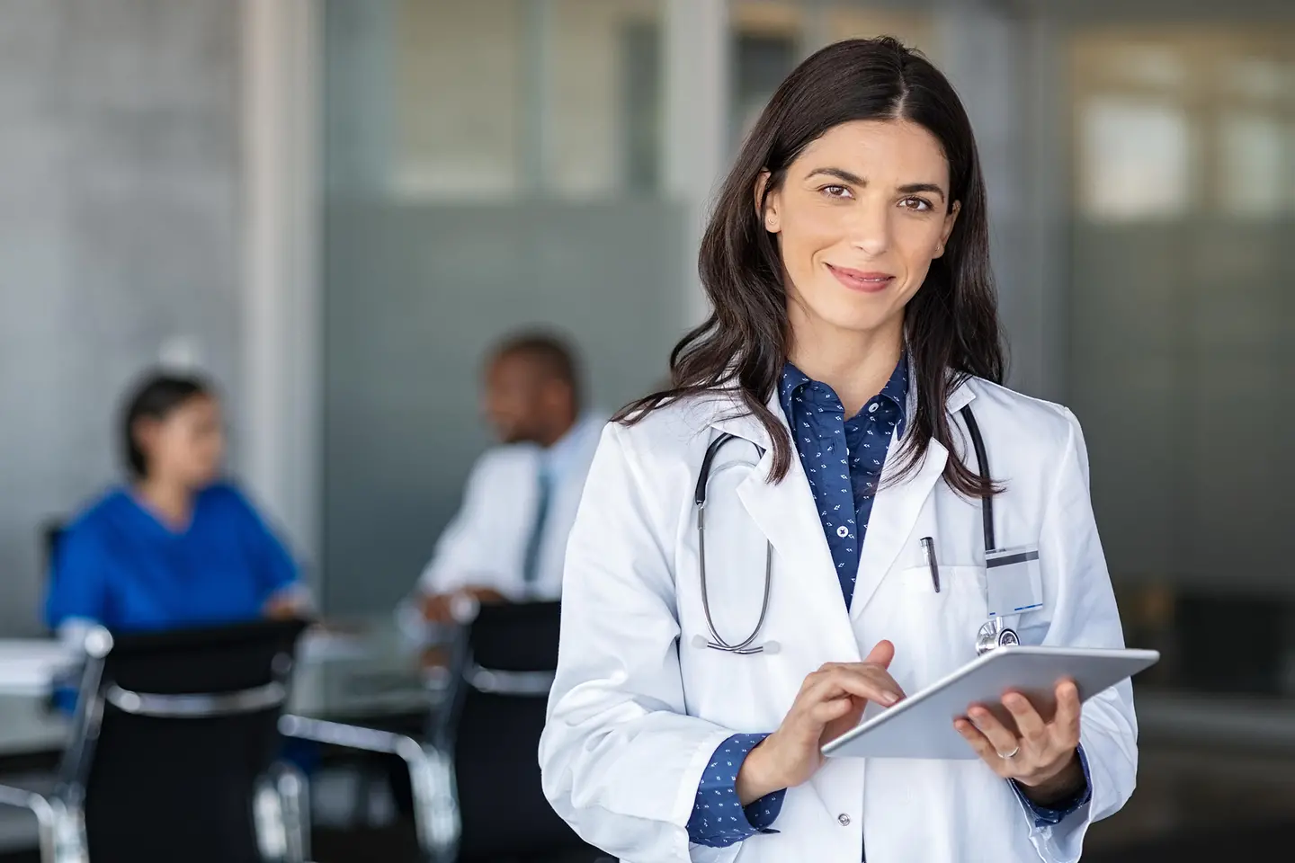 Doctor with tablet in a meeting room