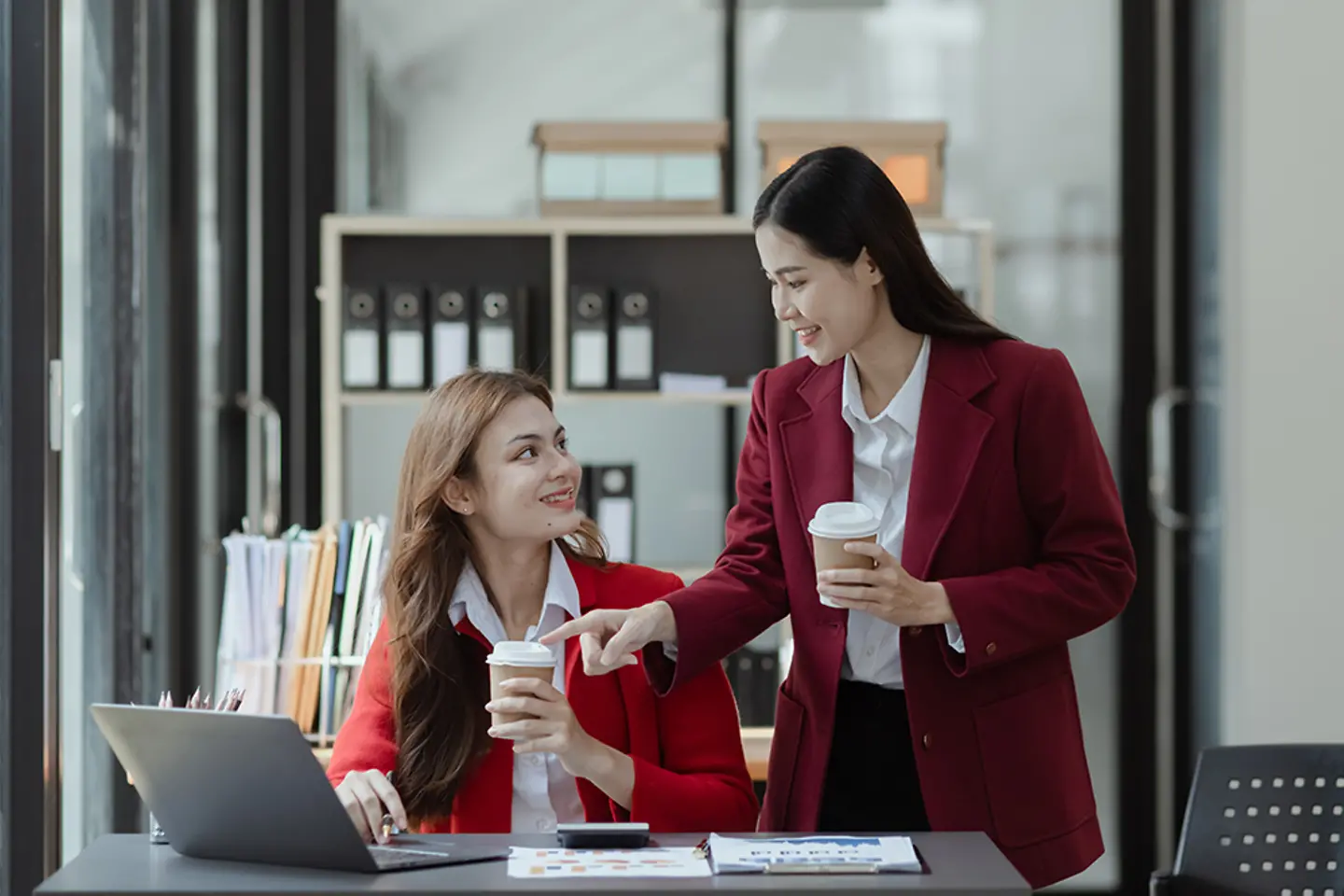 Two business women discussing data